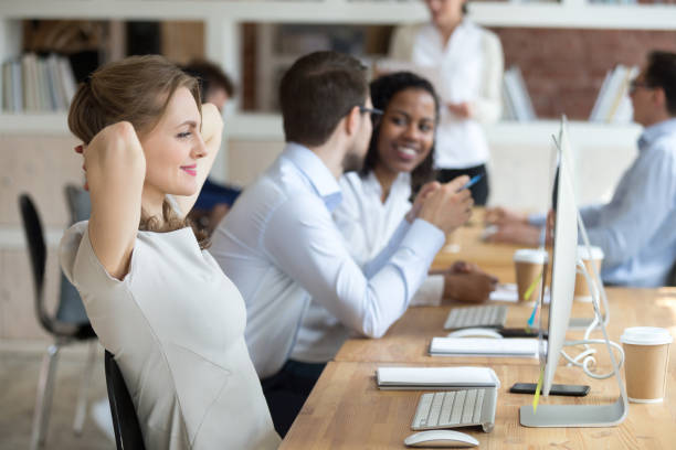 Office workers happily collaborating, emphasizing the significance of accurate payroll for employee satisfaction.